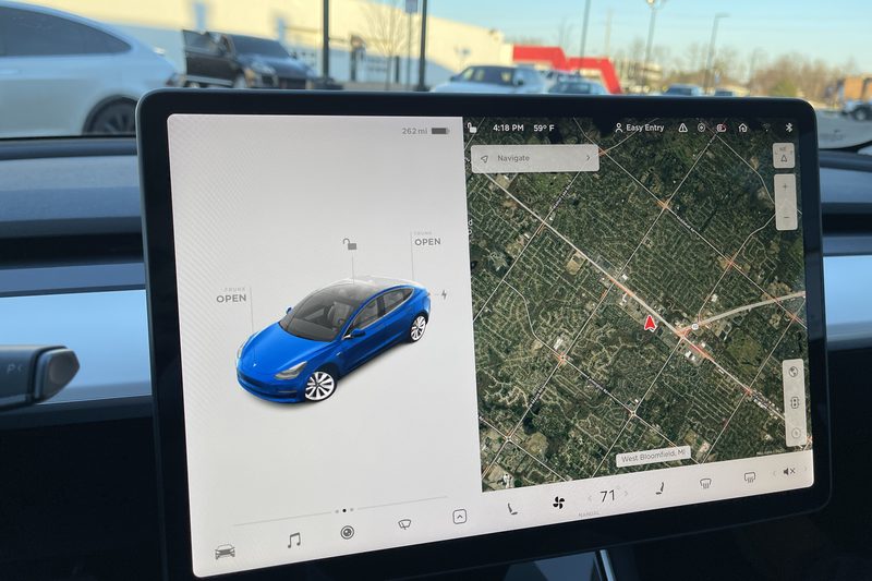The center touchscreen in a Tesla Model 3 showing the car and a map